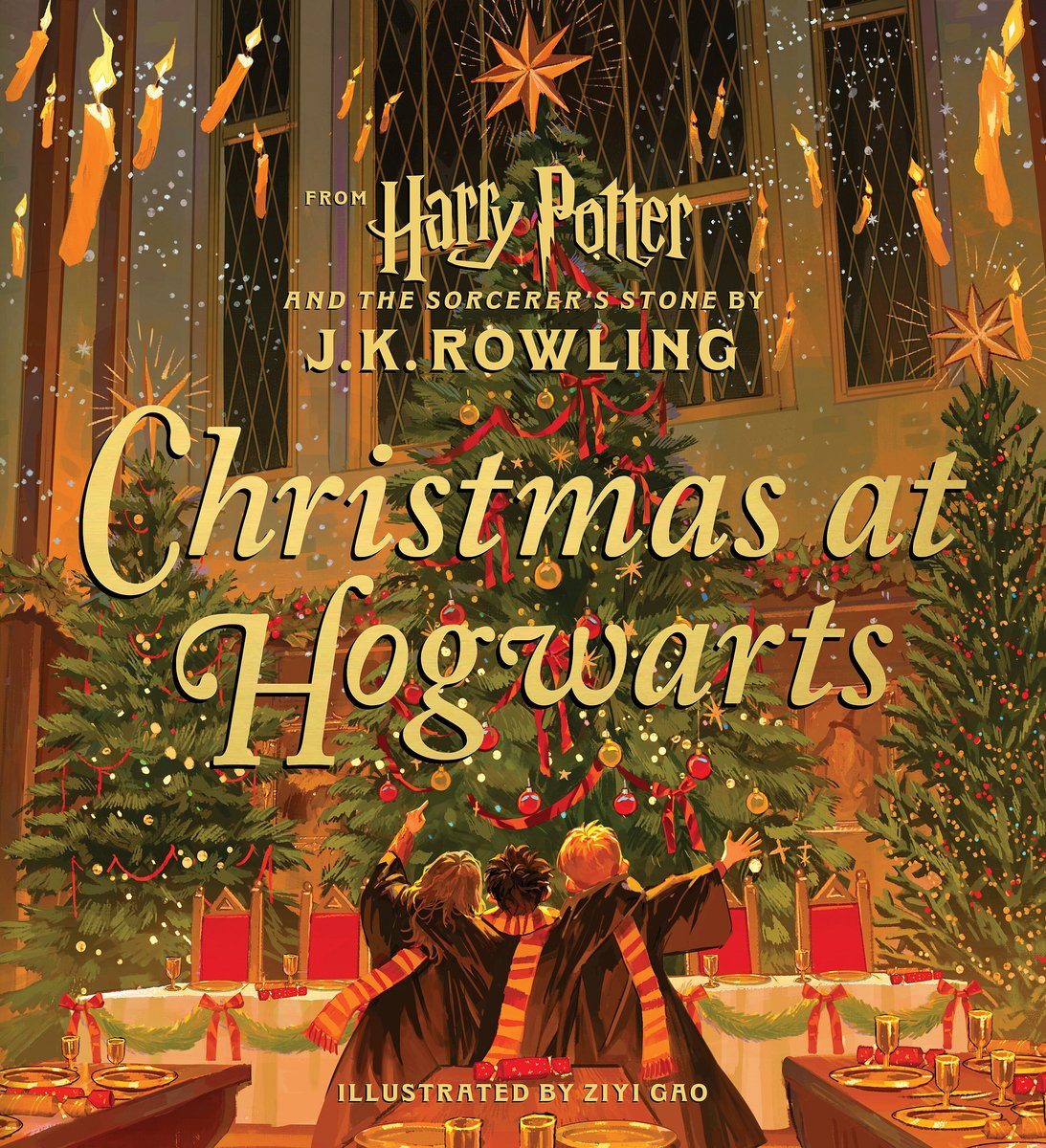 Book cover of "Christmas at Hogwarts," written by J.K. Rowling and illustrated by Ziyi Gao, featuring the rear view of three children in black robes and long yellow-and-red striped scarves looking up at a towering collection of lit Christmas trees, as well as candles that float in midair.