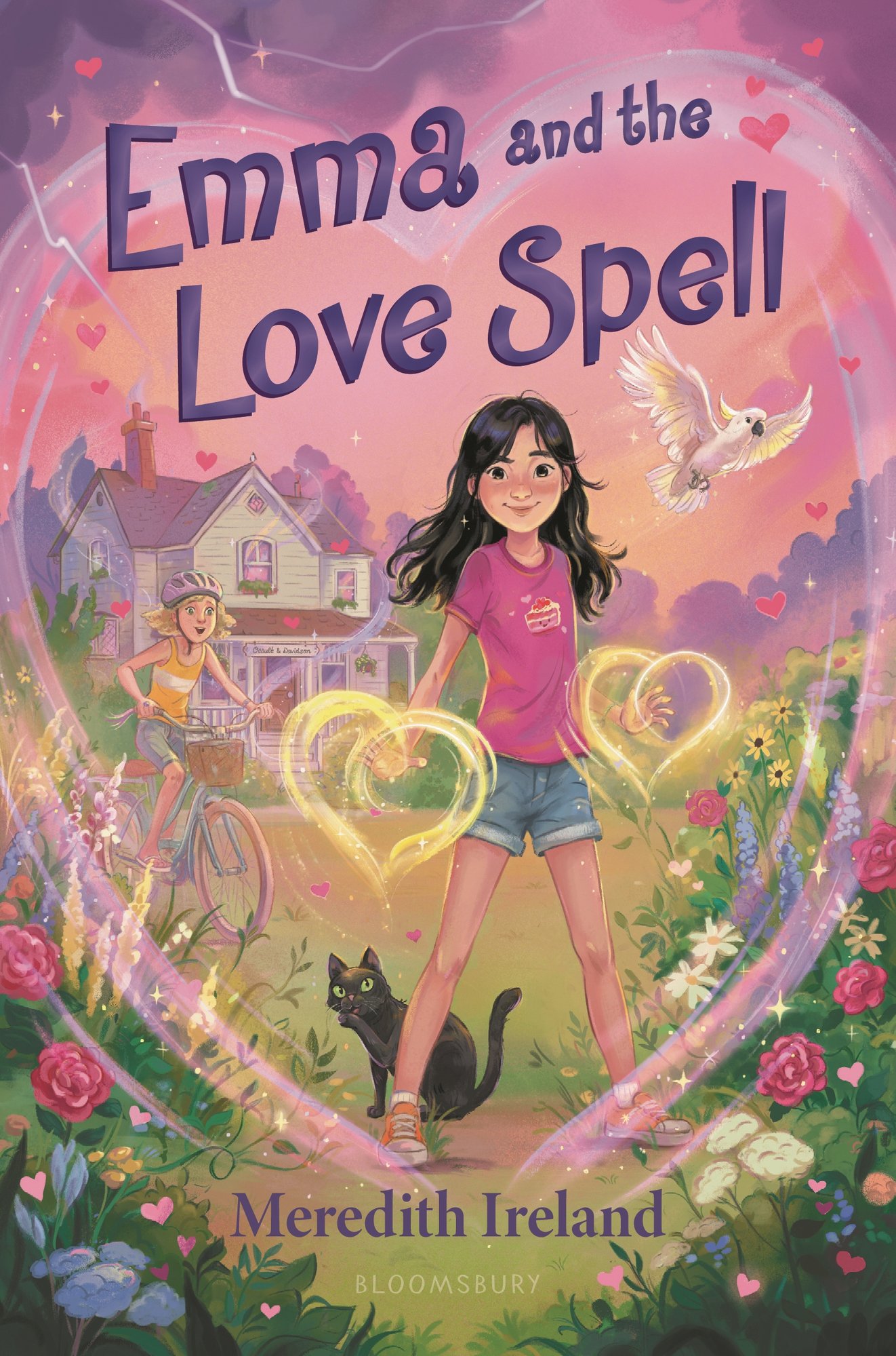 Emma and the Love Spell by Meredith Ireland middle-grade book cover depicting a young girl standing amidst flowers with a black cat at her feet, a white parrot flying behind her, and surrounding her hands are yellow wispy hearts. In the landscape behind her is another young girl on a bicycle, a white house, and a shadowy tree line.