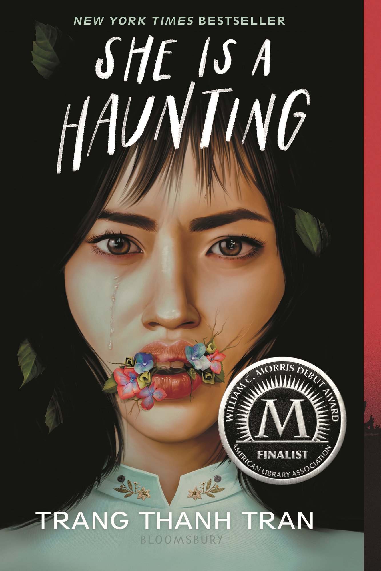 The cover of She is A Haunting, a YA horror novel, depicts an illustrated portrait of a young Asian woman with black hair with a tear trailing down her left cheek. The sides of her mouth are covered with colorful flowers