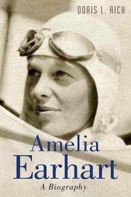 Photo of Earhart with goggles and hat on.