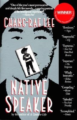 Native Speaker by Chang-Rae Lee. Black and White cover of a man and a small image in front of his mouth of a younger man. To the right is a strip of reviews for the book.