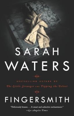 fingersmith book cover black background with dimly lit photo of black wood chest with cream gloves on top
