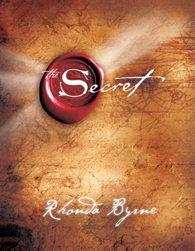 The Secret by Rhonda Byrne book cover. A faded map makes up the background, and the title is written in an ink pen font over a red wax seal.
