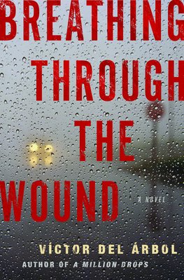 Book cover of 'Breathing Through the Wound' by Victor Del Arbol. A blurry road with a singular car flashing headlights is the background. Dark red title text zig zags from the top-down, and small raindrops scatter across the surface of the background.