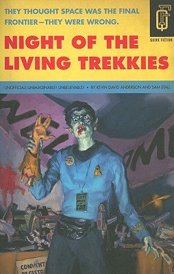 Cover of Night of the Living Trekkies by Kevin David Anderson. A person is wearing a blue Star Trek long sleeve top and a black fanny pack. They are holding up a severed human arm with the fingers posed in a Trekkie sign. 