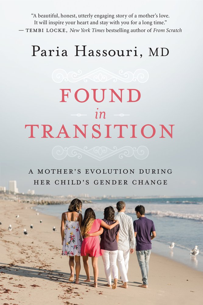 Image shows Hassouri's family on the beach with their backs to the camera. They are walking as one family.