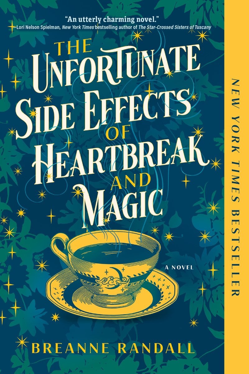 The Unfortunate Side Effects of Heartbreak and Magic by Breanne Randall book cover showing a cup of tea on top of a floral background in dark blues and teal colors. The cup is in a yellow with a single yellow strip on the right side saying "NEW YORK TIMES BESTSELLER" The title is written in yellow and white above the cup with golden sparkles throughout the cover.
