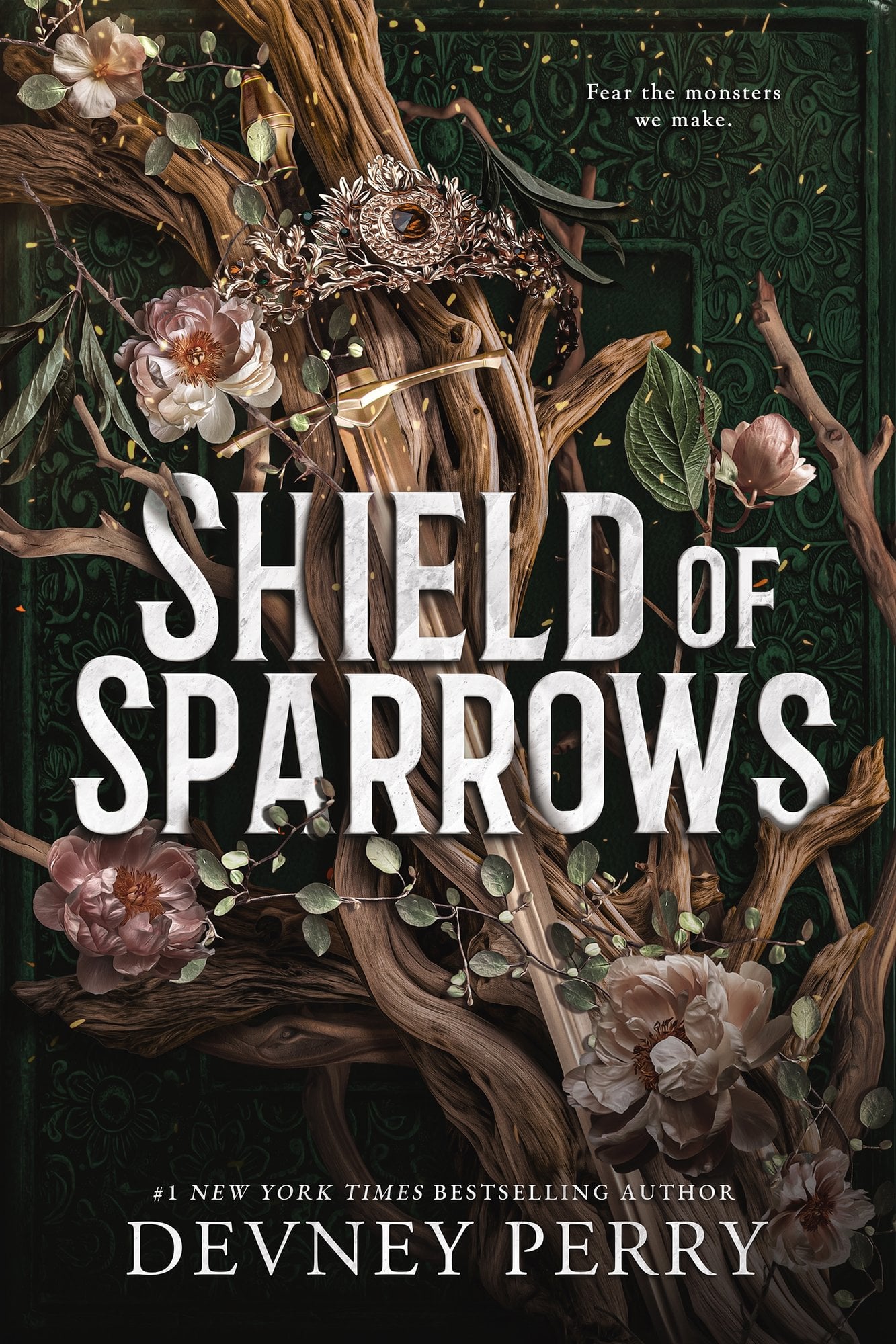Shield of Sparrows by Devney Perry cover has an embossed dark-green background, gnarled branches weave through soft pink flowers and silvery leaves. A delicate, leaf-shaped crown set with a warm amber gem rests among the vines. The large white title dominates the center, with the author’s name below.