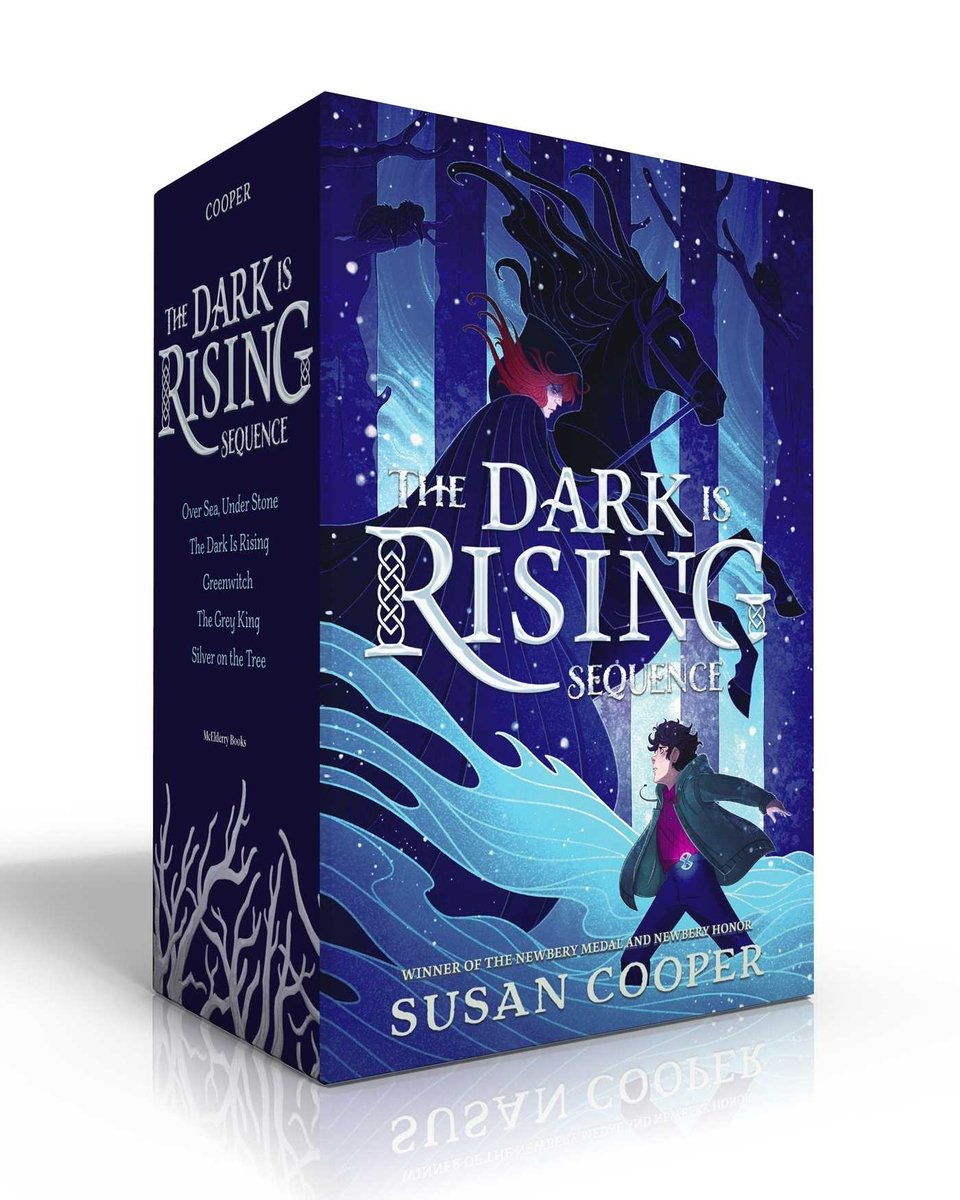 Box set of The Dark is Rising series by Susan Cooper, featuring a light-skinned child with short dark hair facing off against a hooded, light-skinned rider with long red hair riding a towering black horse that is rearing on its back legs in a dark forest.