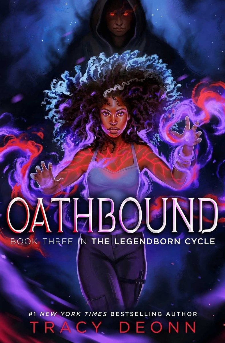 Oathbound by Tracy Deonn has a young Black woman raising glowing hands as violet and crimson magic coils around her. Behind her, a shadowed hooded figure with red eyes watches. Large silver title text stretches across the middle; the author’s name appears at the bottom.