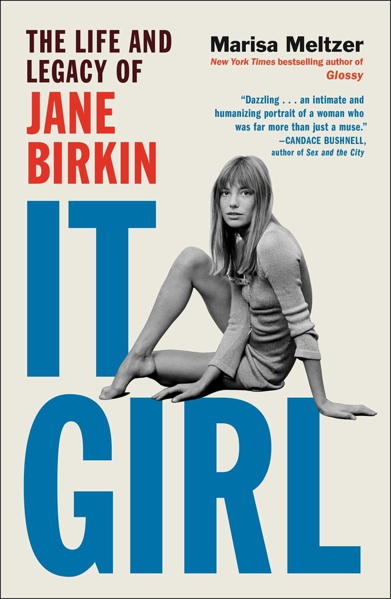 It Girl: The Life and Legacy of Jane Birkin by Marisa Meltzer. A black-and-white photograph of Jane Birkin sitting, legs folded, looking toward the camera. Behind her, the title IT GIRL is printed in large bold blue letters.