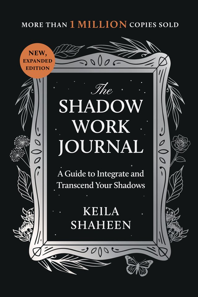 The Shadow Work Journal by Keila Shaheen, book cover. All-black cover with a silver frame around the title, decorated with leaves and flowers.