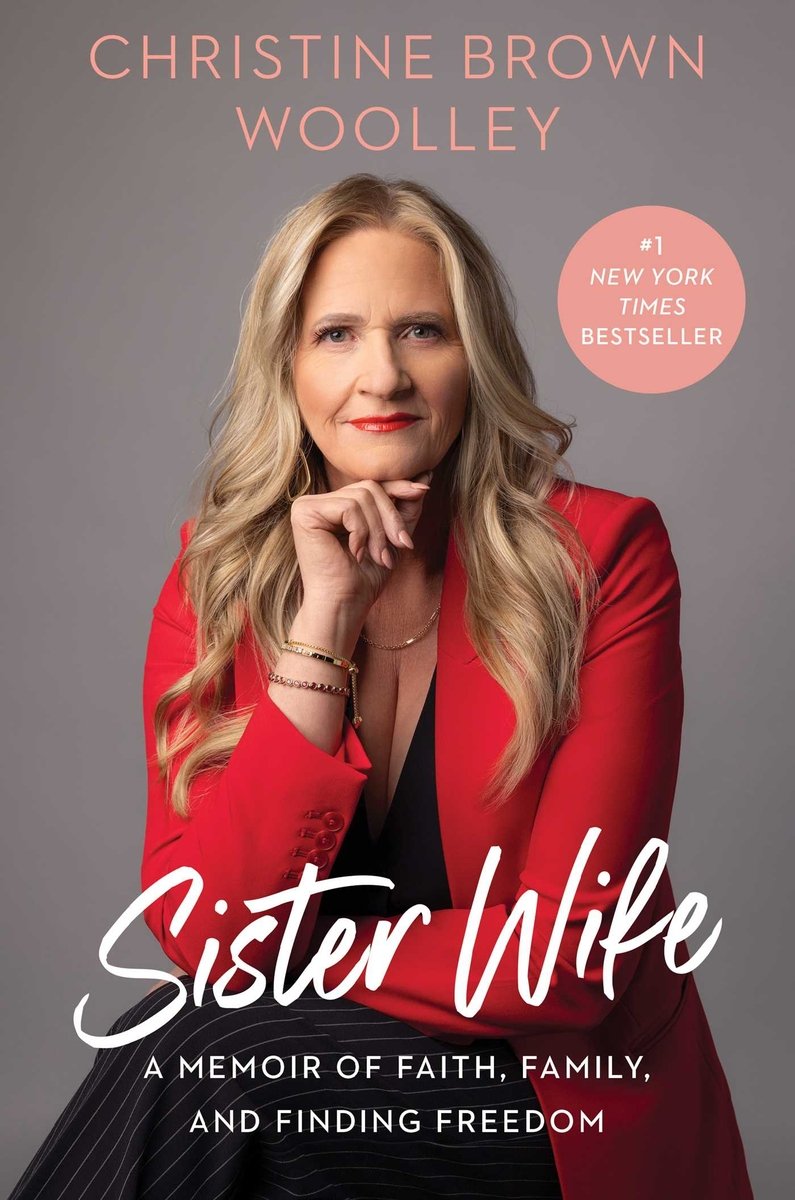 Sister Wife by Christine Brown Woolley, book cover. Christine Brown Woolley sits on a chair with black striped pants and blouse paired with a red blazer. Her legs are crossed as she stares straight at the camera with her hand pressed to her chin.