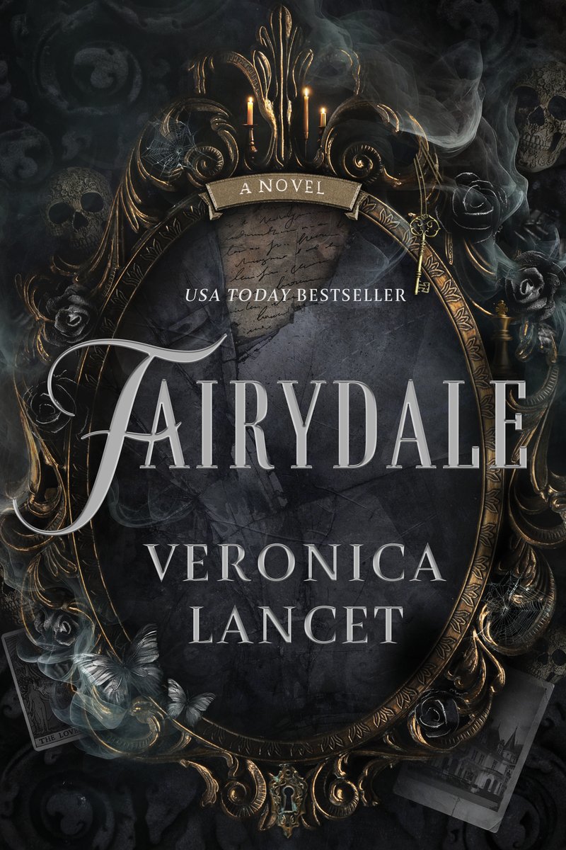 Cover of Fairydale by Veronica Lancet. There is an intricate mirror that is shattered in the center, and looks to be old gold. There is grey smoke around the mirror with skulls, butterflies, and polaroid photos scattered around the edges. It is all dark themed.