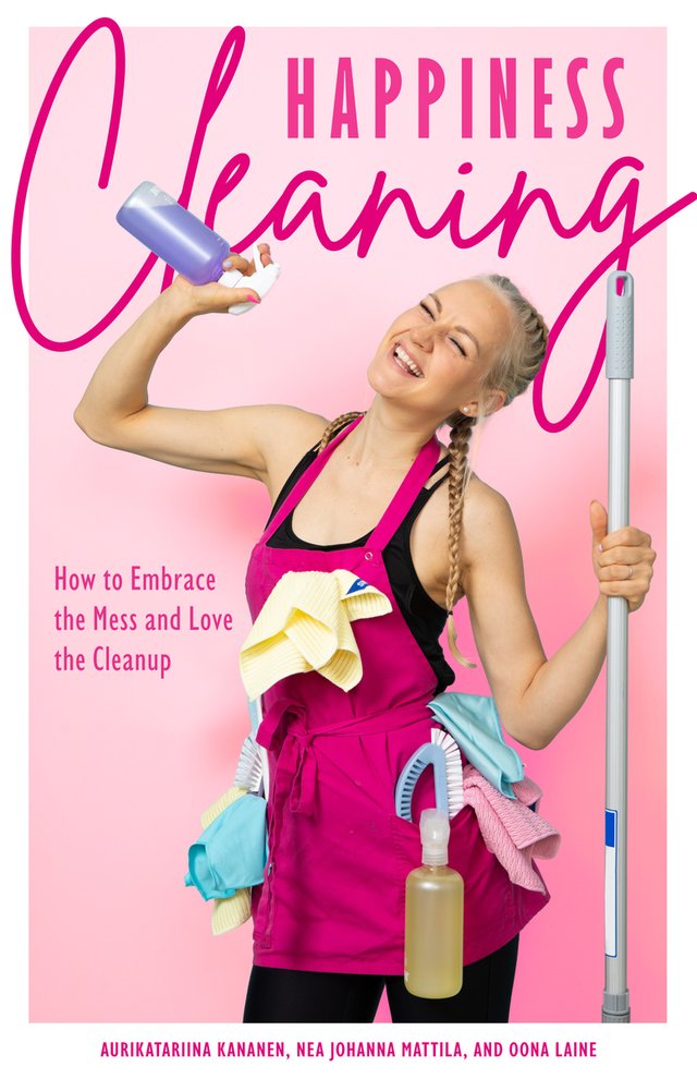 Happiness Cleaning by Aurikatariina Kananen and Oona Laine, Translated by Nea Johanna Mattila, young woman in pink cleaning apron holding blue squirt bottle, yellow, blue, and pink rags on apron, holding a mop in the other hand, pink background, pink title, book cover