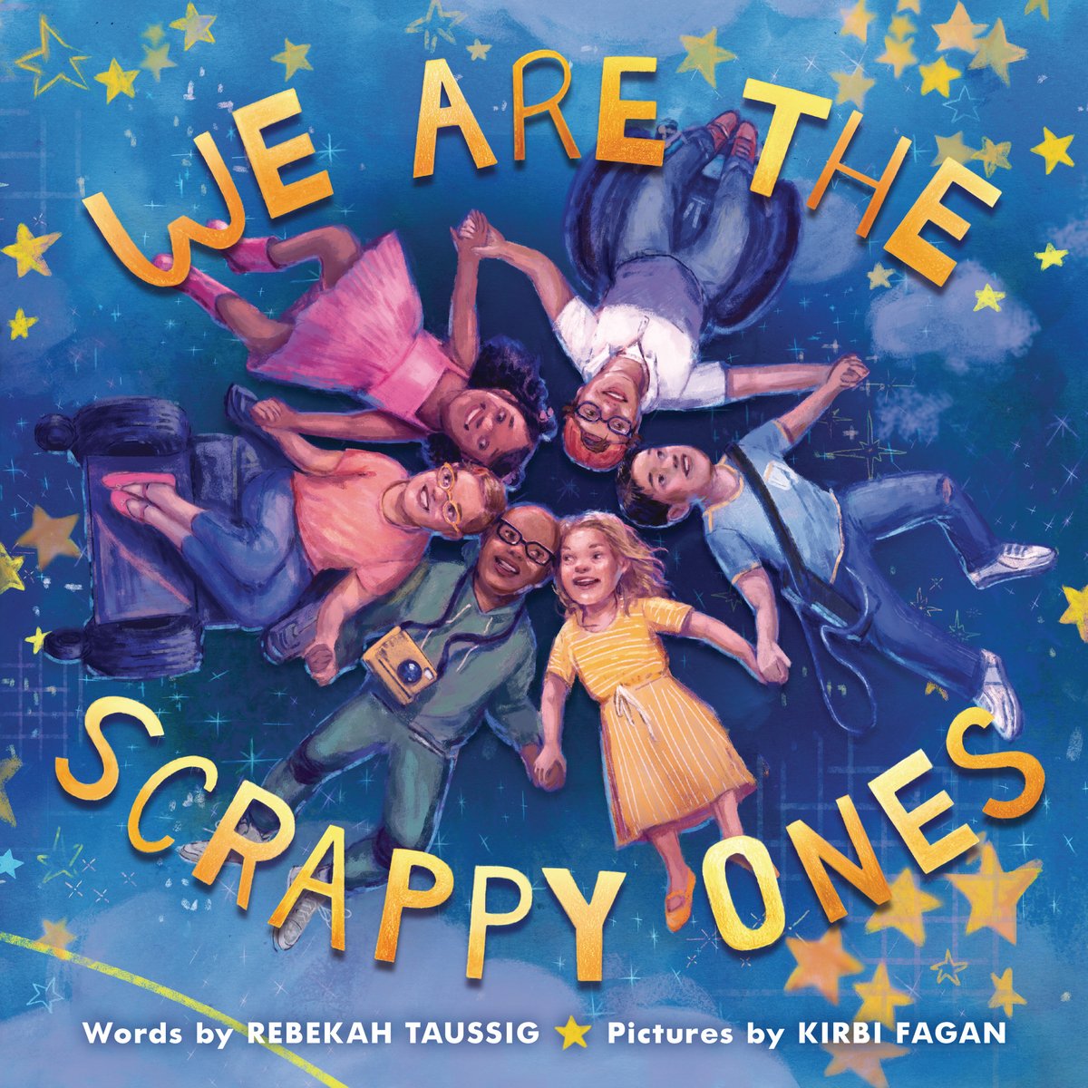 Book cover of We Are the Scrappy Ones by Rebekah Taussig, Illustrated by Kirbi Fagan, featuring a group os children diverse in skin tone, hair color/texture, and ability lying in a circle while holding hands; they are staring up into a sky full of stars and smiling.