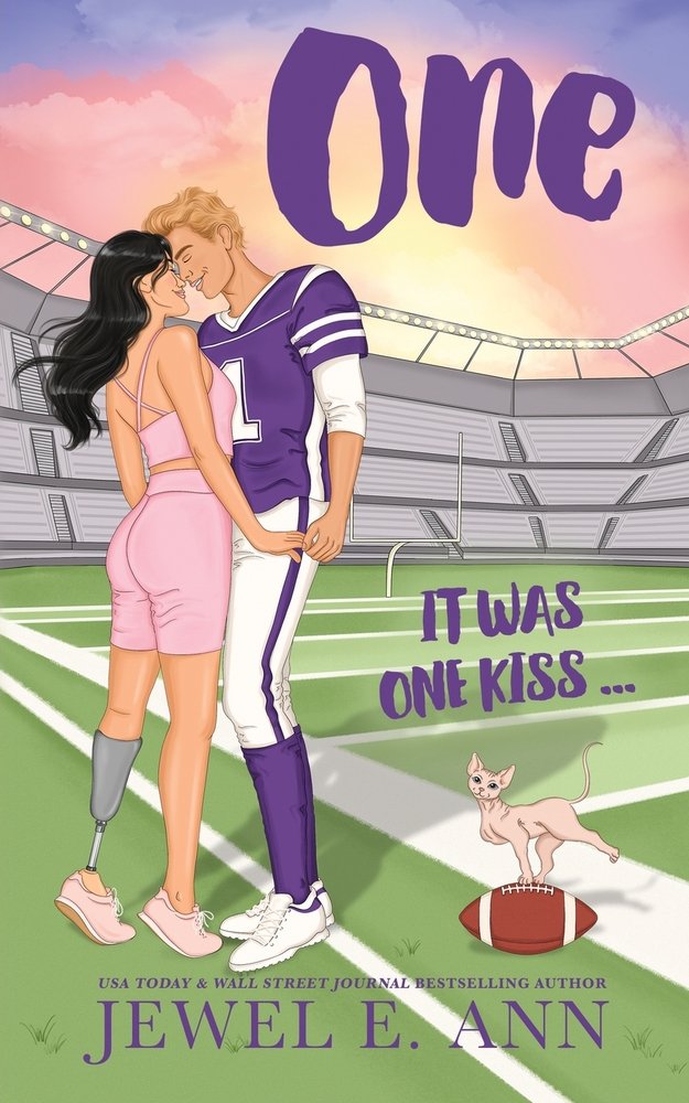 One by Jewel E. Anne book cover. Lake and Cage kissing on a football field while a hairless cat balancing on a football sits nearby.