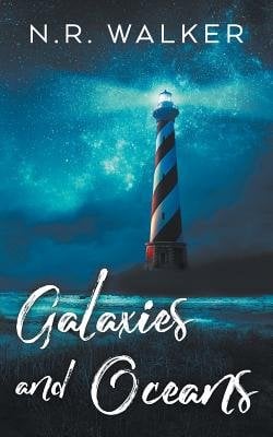 Book cover of Galaxies and Oceans by N.R. Walker. A red and white striped lighthouse casts a blue beam of light into a dark, cloudy sky. The title is written in white looping script.