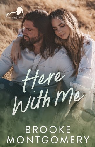 The cover of Here With Me by Brooke Montgomery. There is a photo of a man and woman sitting and cuddling next to each other. They are seated in a field.