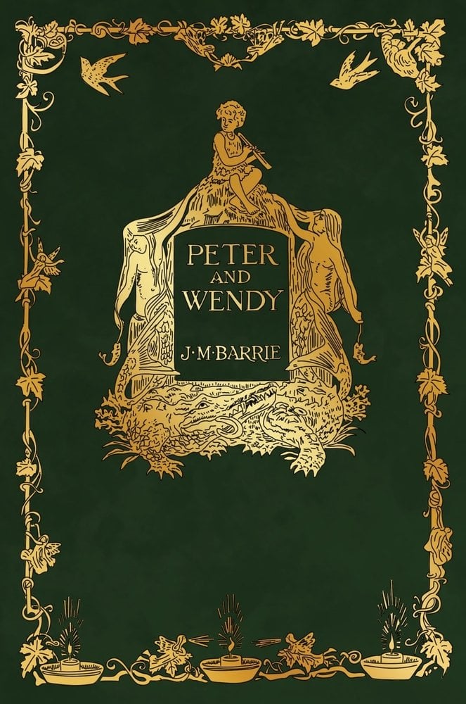 Peter and Wendy by J.M. Barrie's book cover depicts a fantasy style green back ground with intricate gold detailing. A young boy with a flute sits atop a rock surrounded by mermaids and an alligator, all in the same gold detailing.
