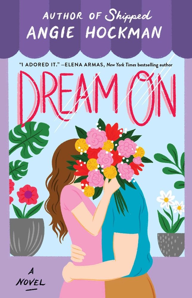 The book cover for Dream On by Angie Hockman. A display window framed in purple featuring red, green, and white plants. Standing in front of the window, a man and woman embrace. The woman has pale skin, brown hair, and a pink shirt. The man has pale skin and a blue shirt. The woman holds a bouquet of pink, yellow, and red flowers over both of their faces, completely obscuring the man' head.