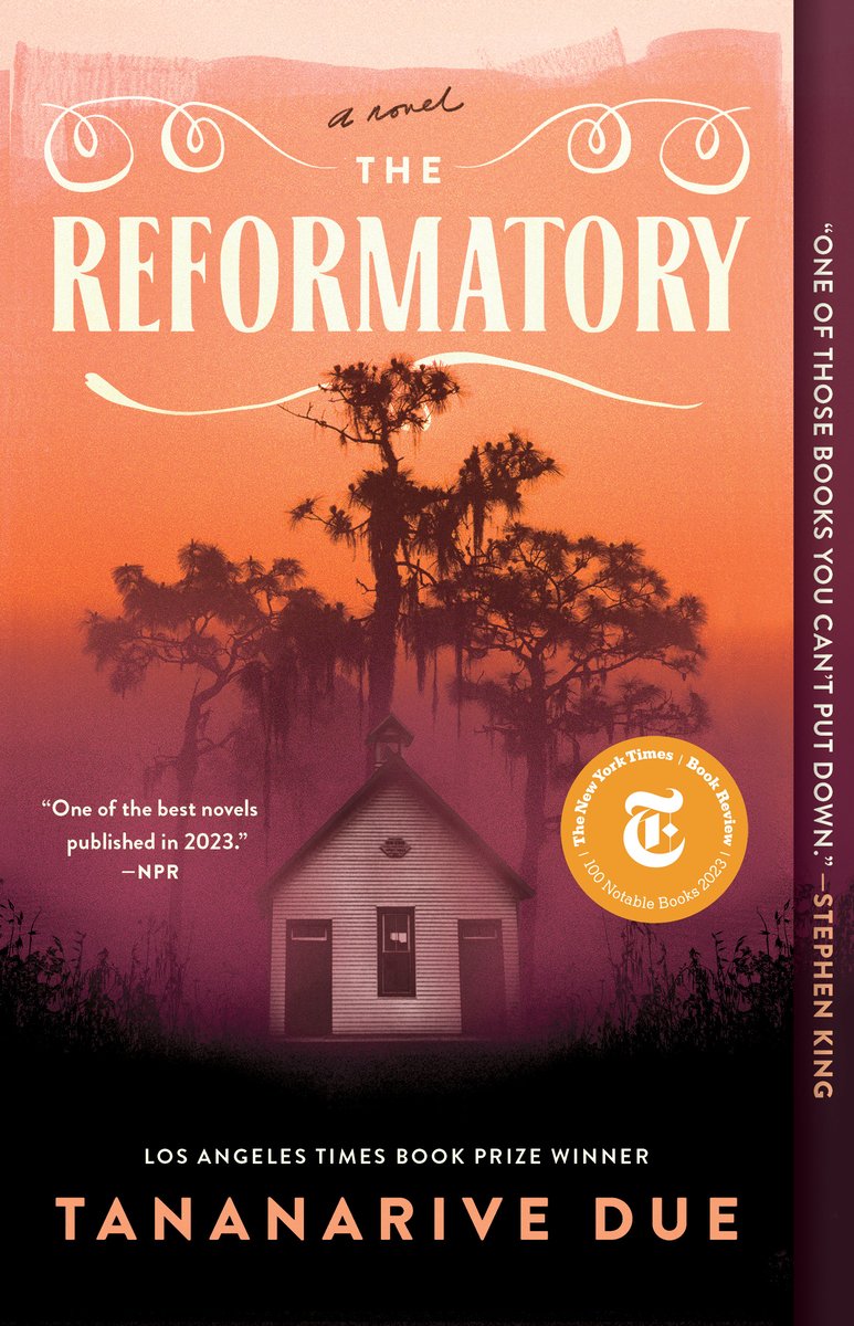 Book cover for "The Reformatory" by Tananarive Due. Orange-toned atmospheric image featuring a small white building silhouetted against a sunset/sunrise sky with Spanish moss-draped trees. The title "THE REFORMATORY" appears in large white letters with decorative eye designs above it and "a novel" in script. A New York Times Notable Book 2023 medallion is visible. NPR quote reads "One of the best novels published in 2023." Text indicates it's a Los Angeles Times Book Prize Winner. The author's name appears at the bottom, with text along the spine reading "ONE OF THOSE BOOKS YOU CAN'T PUT DOWN" - Stephen King.