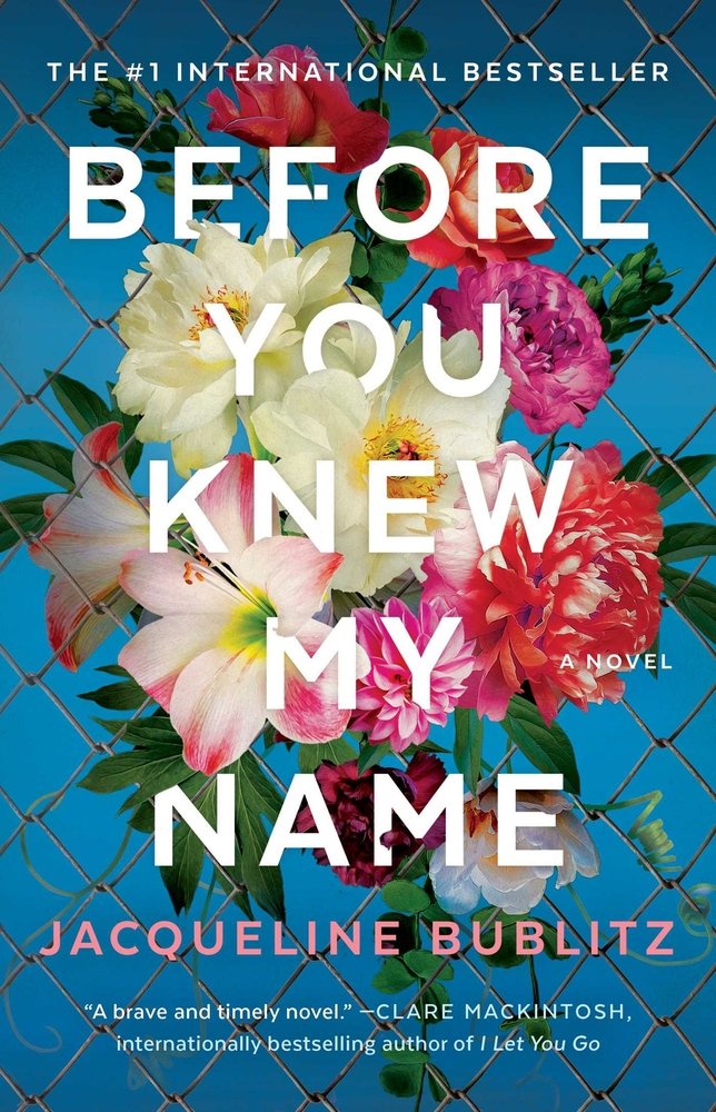 Before You Knew My Name by Jacqueline Bublitz book cover, a bouquet of assorted red, pink, and white flowers hanging on a chainlink fence.