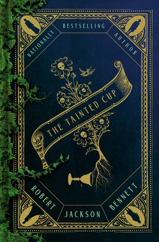 The Tainted Cup by Robert Jackson Bennett, book cover. The title is written on a spilled out scroll that covers a group of flowers with skulls in the center and exposed roots. By the flowers' roots is a knocked-over chalice. There is a decorative black and gold border that has a different black figure on each pointed corner. On the left side, there is green moss growing over the book cover.