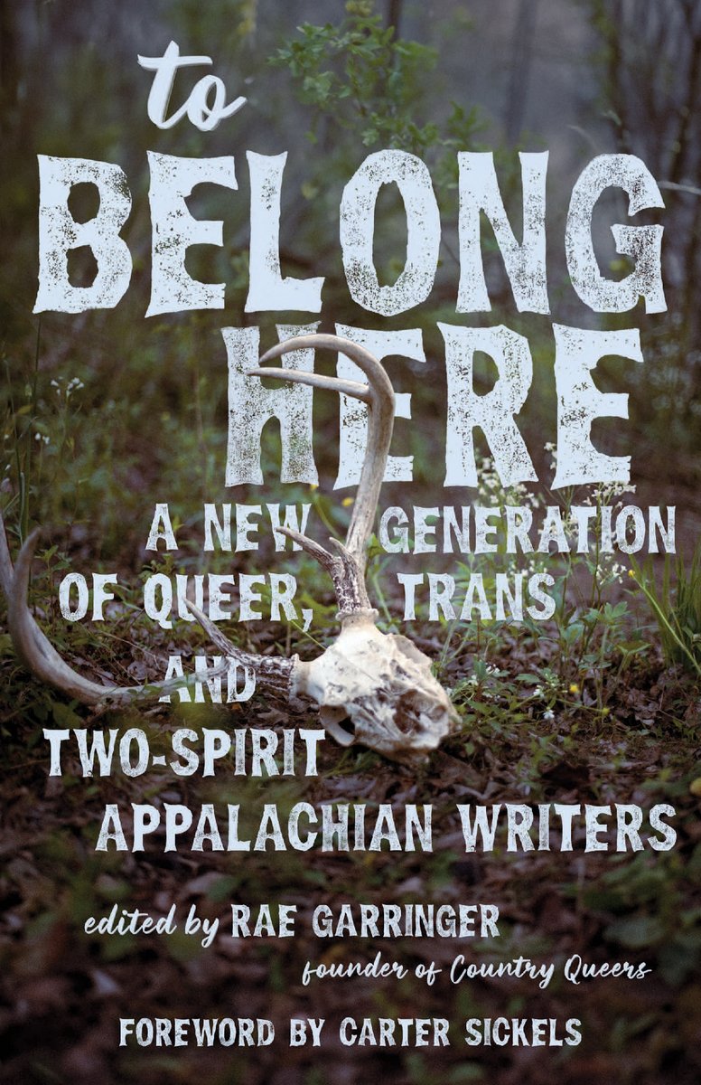 The book cover for To Belong Here by Rae Garringer. A deer skull in the middle of a dreary wooden area. The title and author's name are in a blue, bold font.