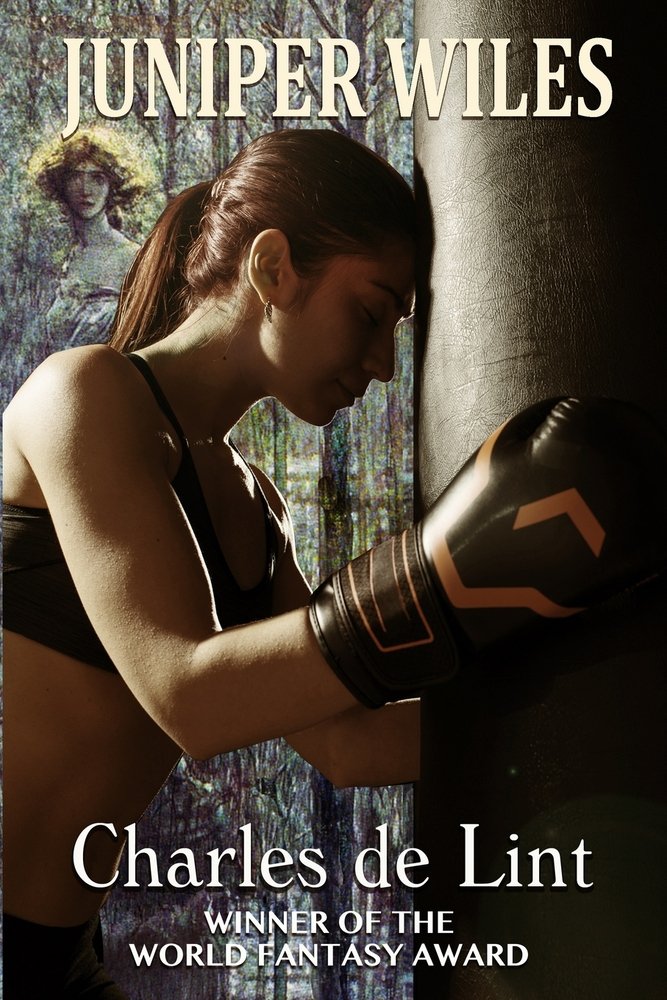 Juniper Wiles de Charles de Lint. A woman with boxing gloves leans her head into a punching bag, the face of a statue looking over her shoulder.