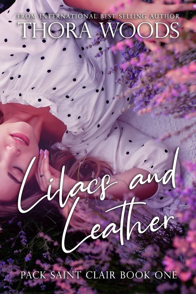 Pack Saint Clair book one, Lilacs and Leather by Thora Woods omegaverse book cover depicting a woman laying on the ground surrounded by lavender.