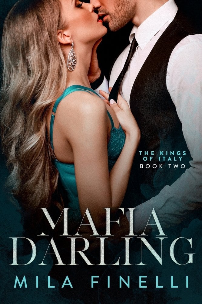 Mafia Darling by Mila Finelli, book cover. The title "Mafia Darling" is written on the bottom. There is a photo of a man kissing a man in a blue dress. He is wearing a tux and she is holding onto his tie.